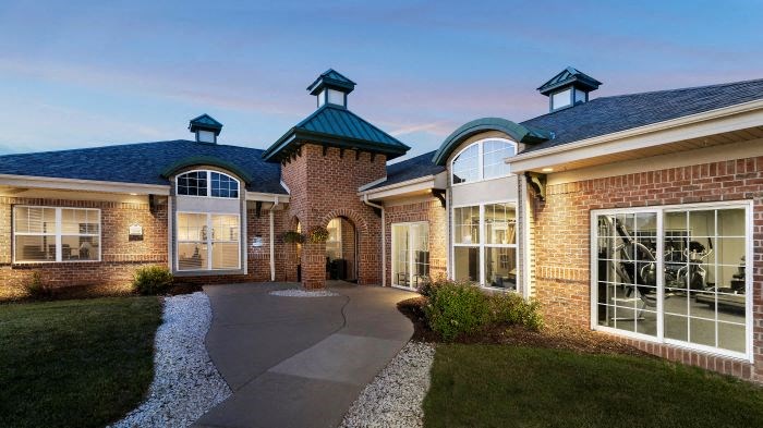 a brick house with a walkway in front of it