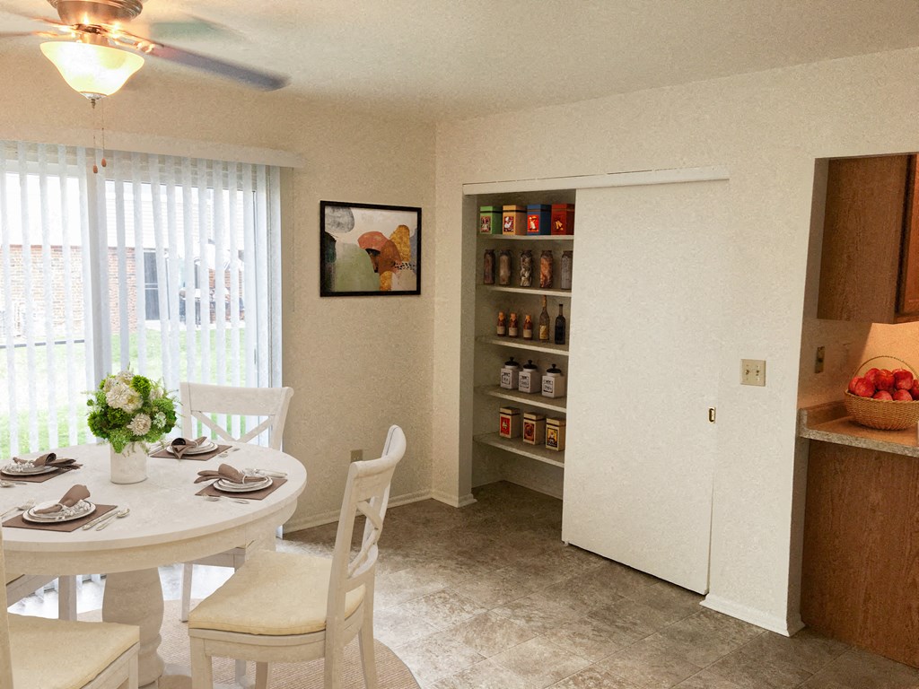 a kitchen and dining room with a table and chairs and a refrigerator