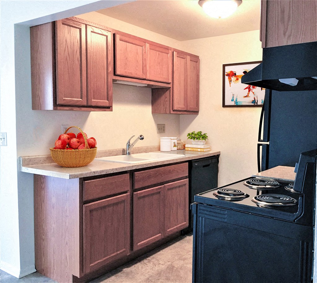 a kitchen with wooden cabinets and a black stove