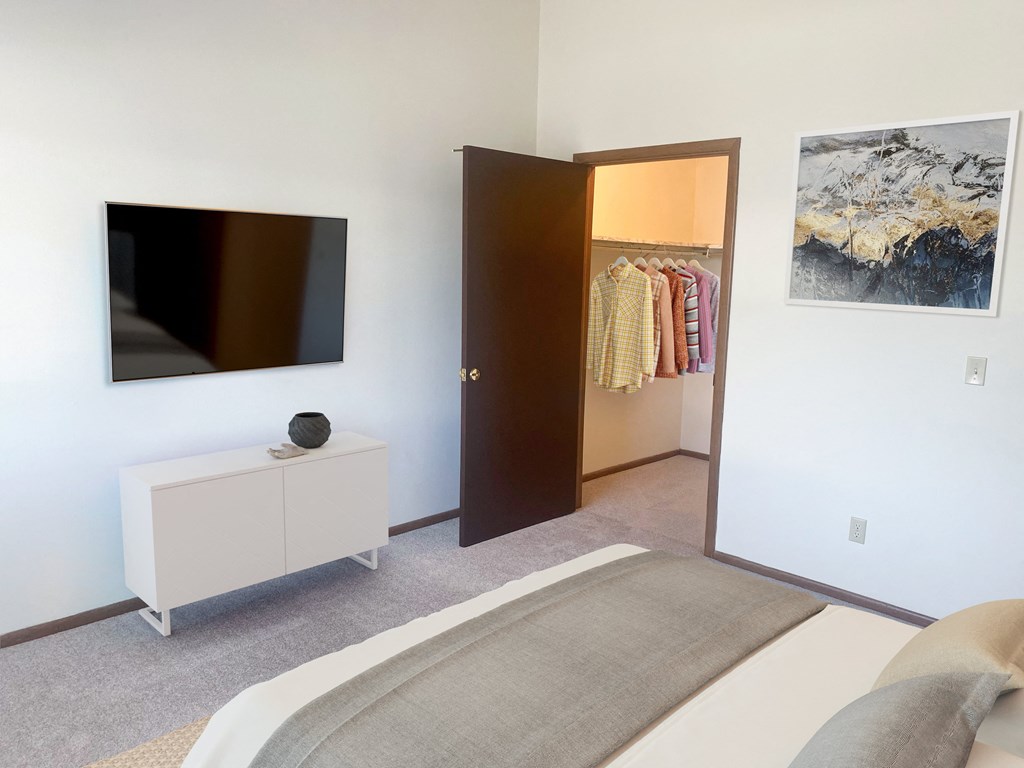 a bedroom with a bed and a door to a closet