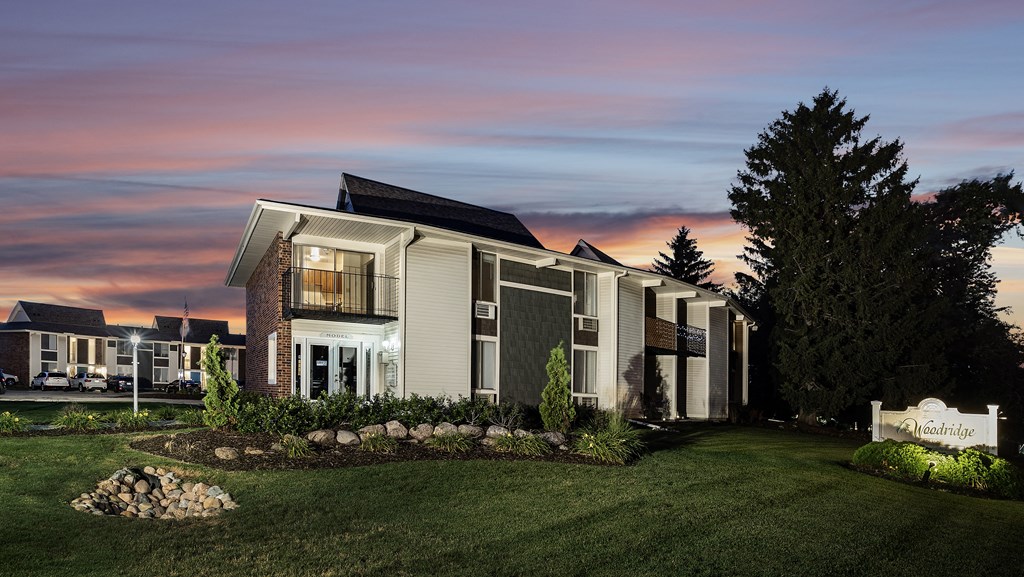 a view of a house with a sunset behind it