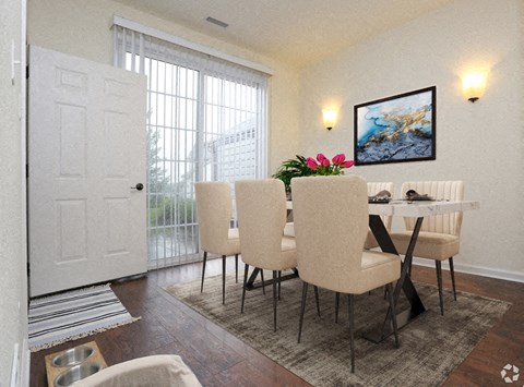 a dining room with a table and chairs and a door