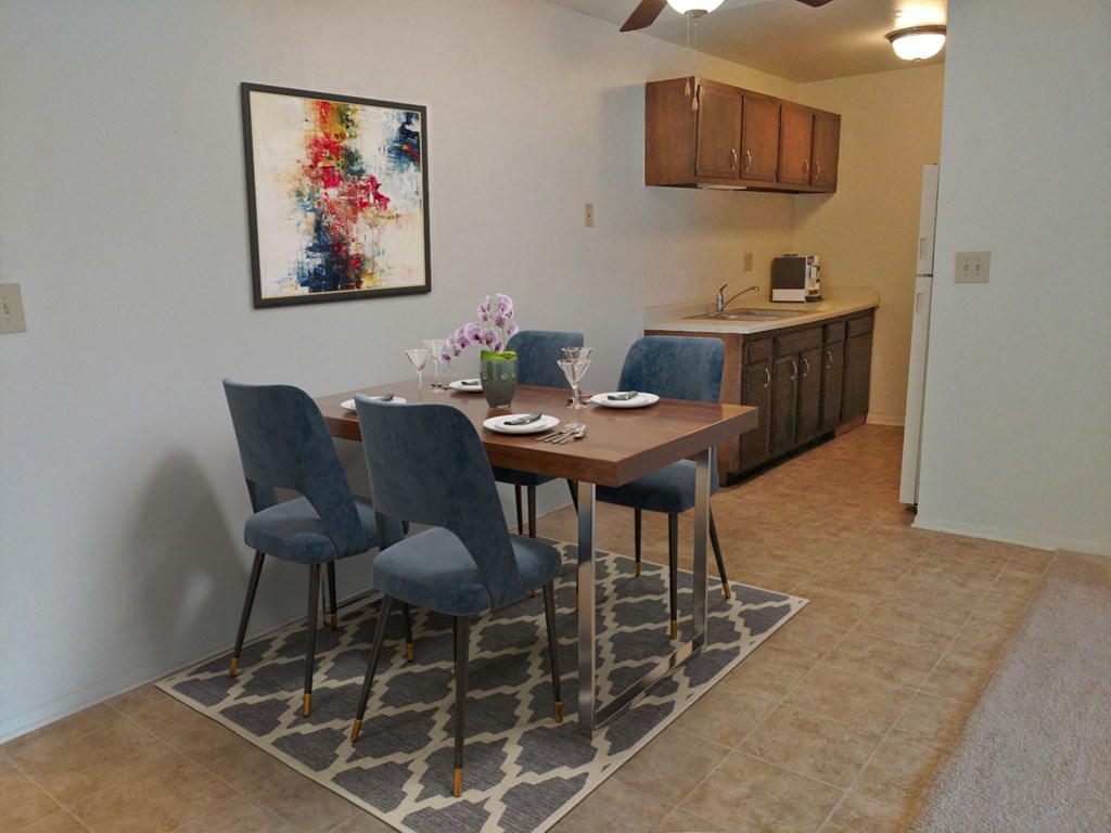 a dining room with a table and chairs and a kitchen
