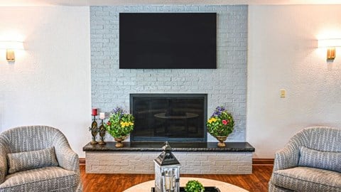 a living room with a fireplace and a tv on the wall
