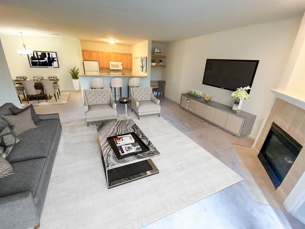 a living room with couches and chairs and a fireplace