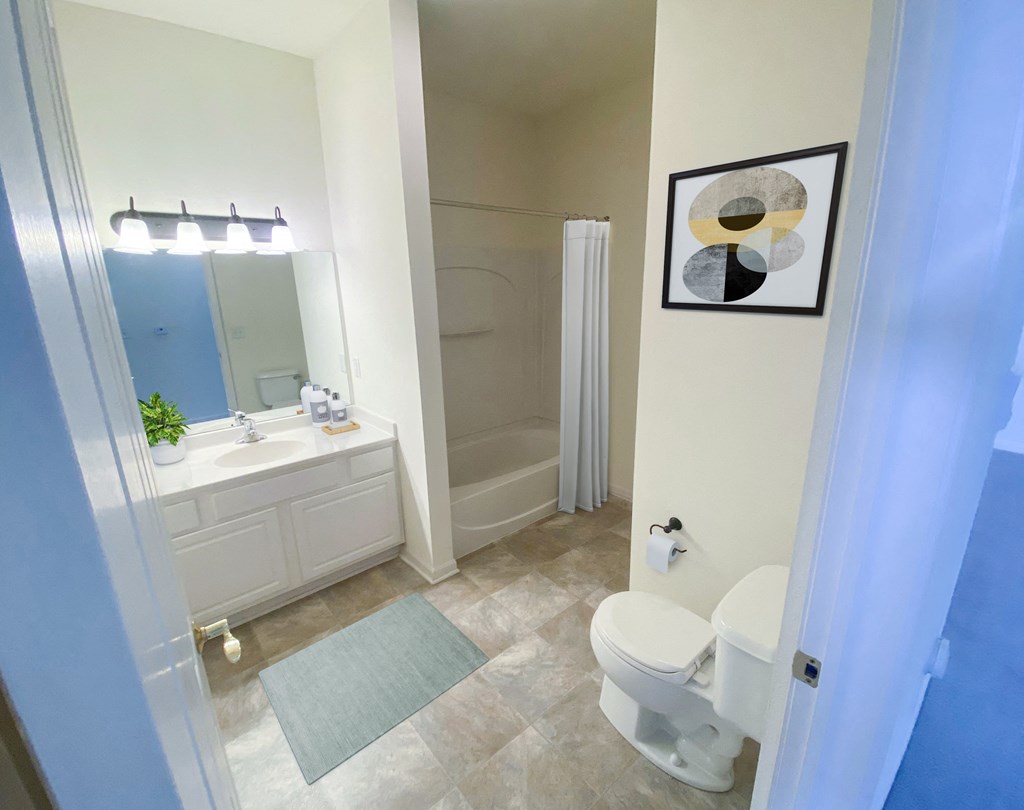 a bathroom with a white toilet next to a white sink