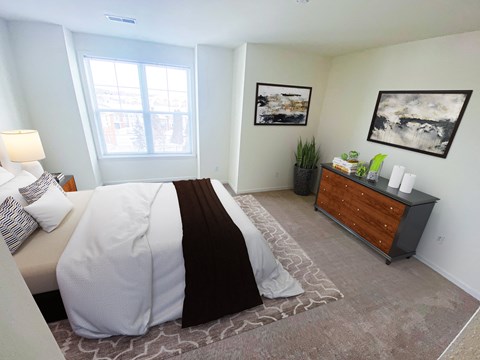 a bedroom with a large bed and a dresser