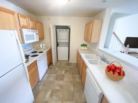 a kitchen with wooden cabinets and a sink and a refrigerator