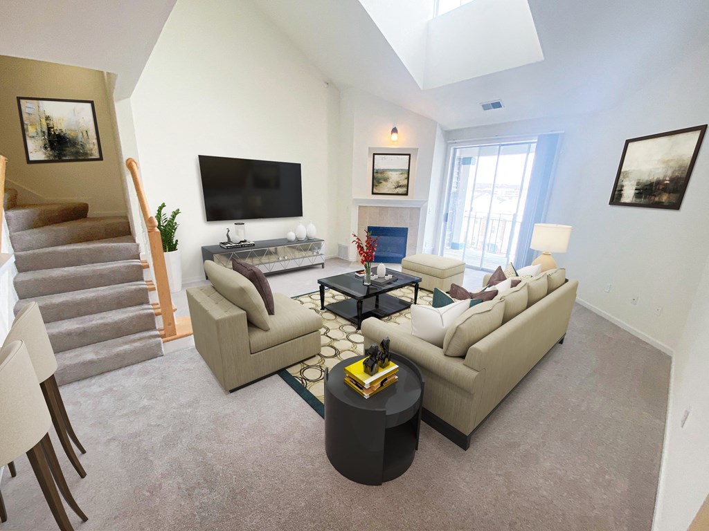 a living room with white walls and a vaulted ceiling