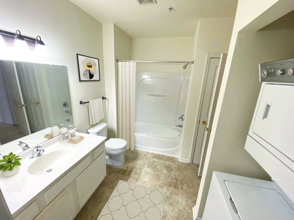 a bathroom with a toilet sink and shower