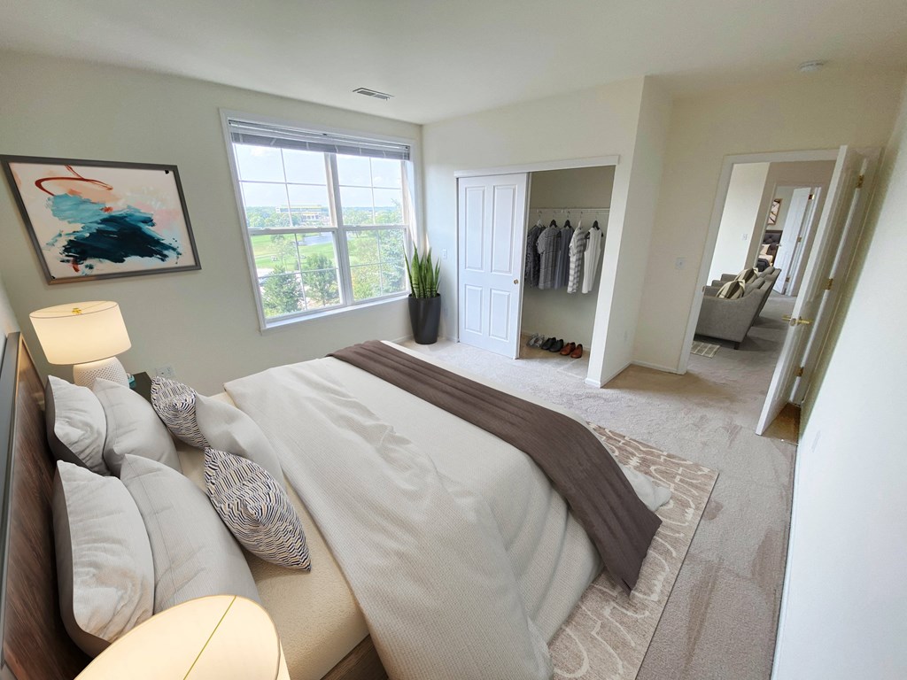 a bedroom with a large bed and a walk in closet
