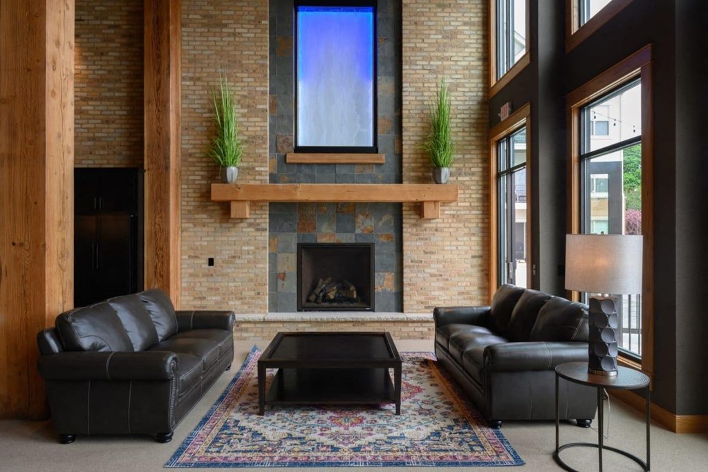a living room with leather couches and a fireplace