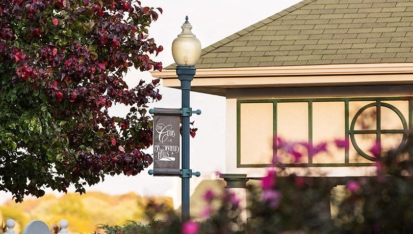 a sign on a lamp post in front of a building
