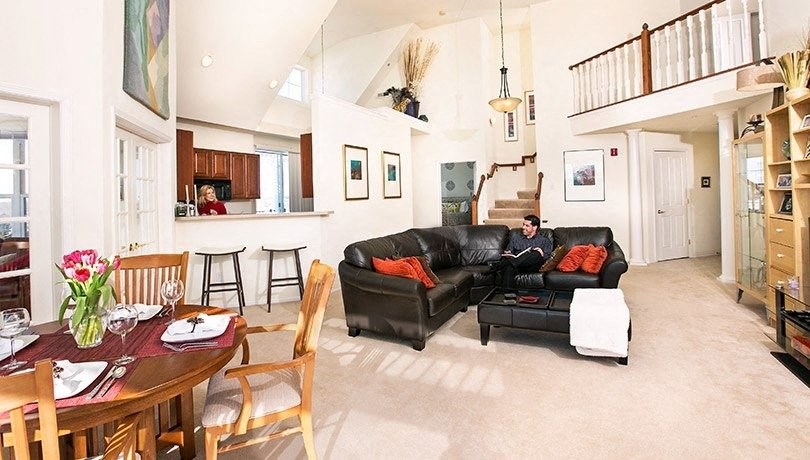 a man sitting on a couch in a living room