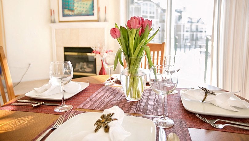 a table with a vase of flowers on top of it