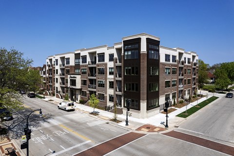 an aerial view of an apartment building on a city street