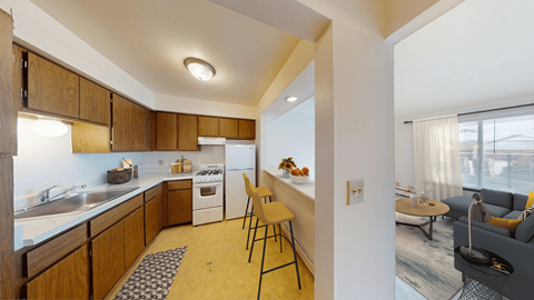 A kitchen with wooden cabinets and a white refrigerator.