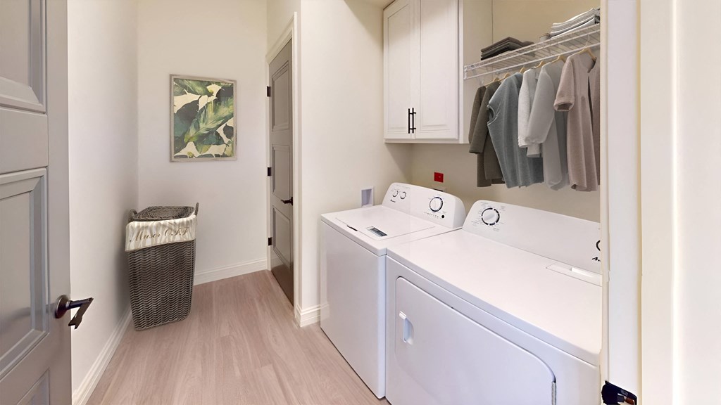 a laundry room with a washer and dryer and a closet