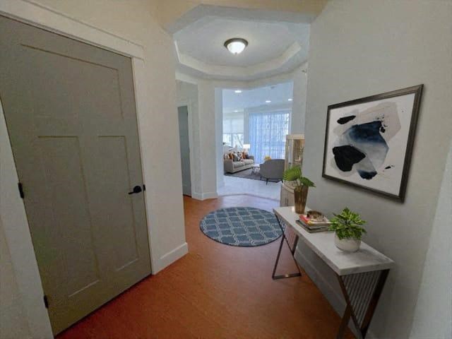 a hallway with a white door and a painting on the wall