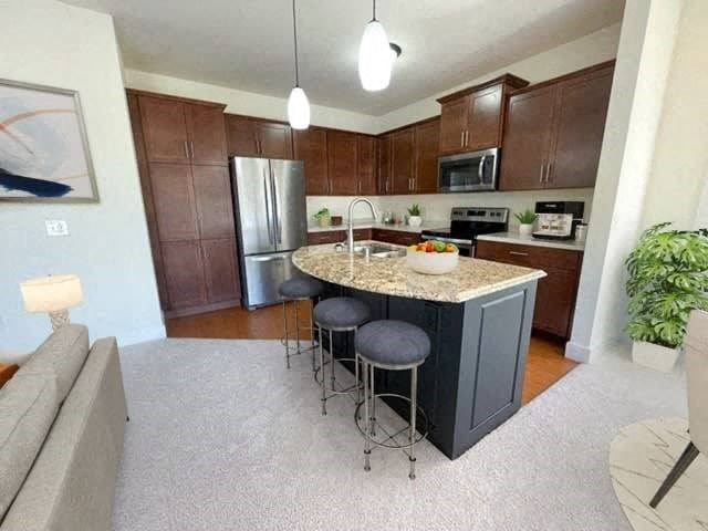 a kitchen with a center island with three stools
