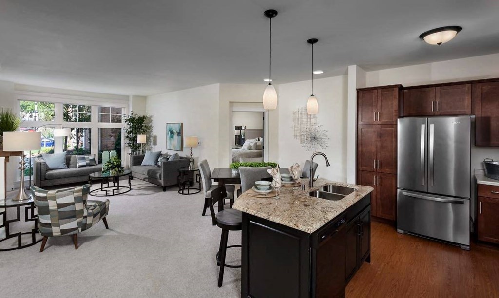 a kitchen and living room with a refrigerator