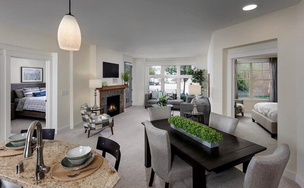 the living room has a fireplace and a table with chairs