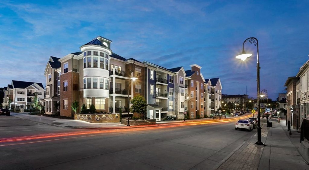an apartment building on a city street at night