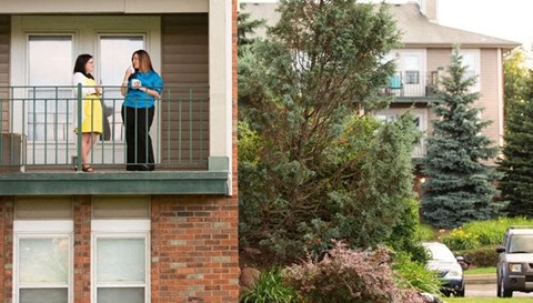 two women standing on a balcony talking to each other