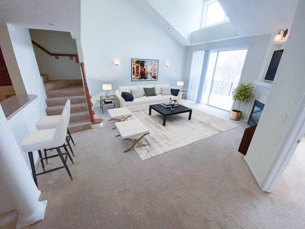a living room with white walls and carpet