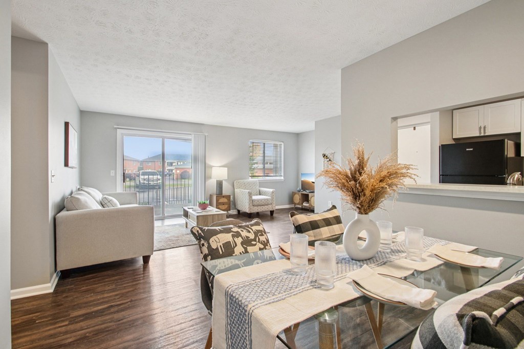 A modern living room with a glass table and a couch.