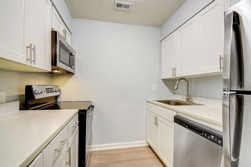 Renovated Apartment Home Kitchen at Fernwood Grove Apartments at 4900 MacDill Ave in Tampa, Florida 33614