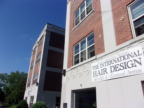 A building with a sign that says "The International Hair Design" on it.