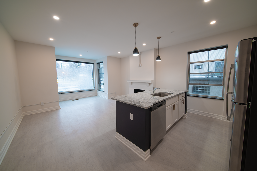 an empty kitchen with an island in the middle