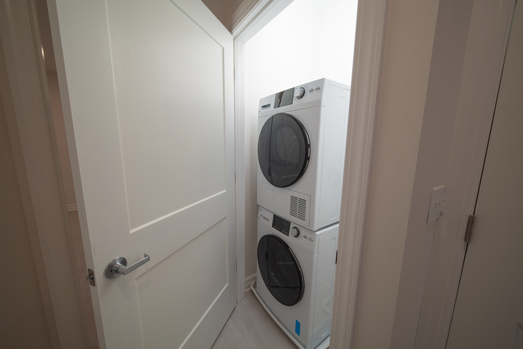 a front loading washer and dryer in a small closet