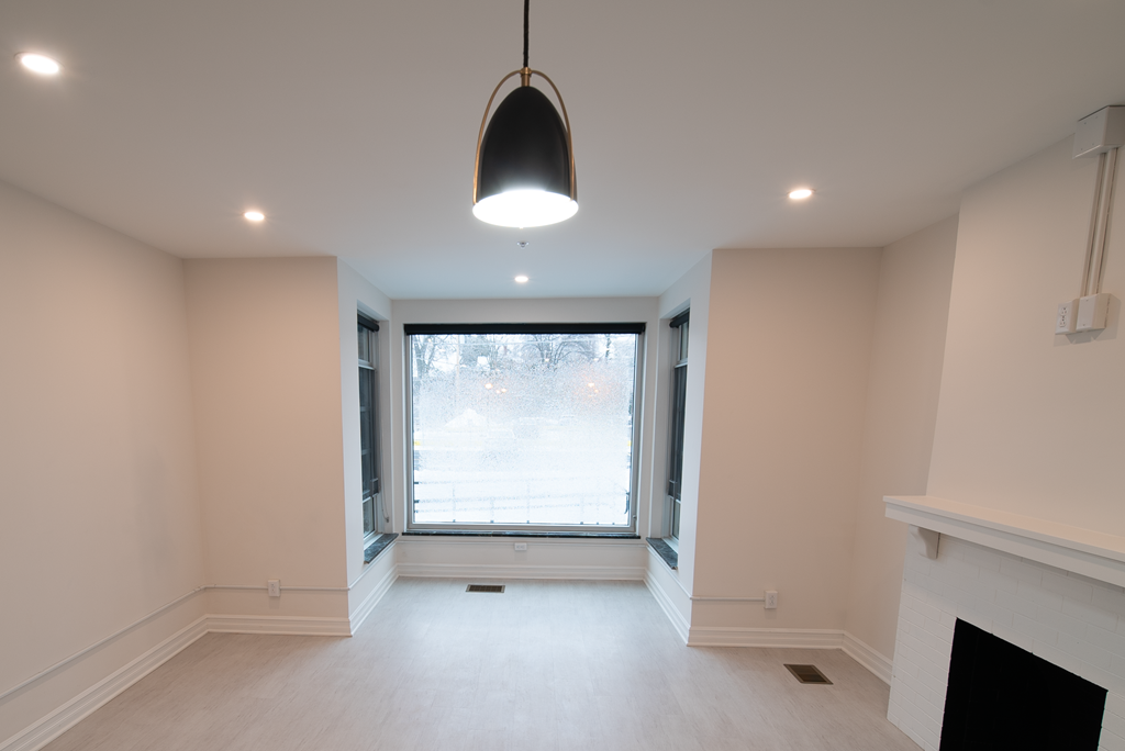 a large empty living room with a large window