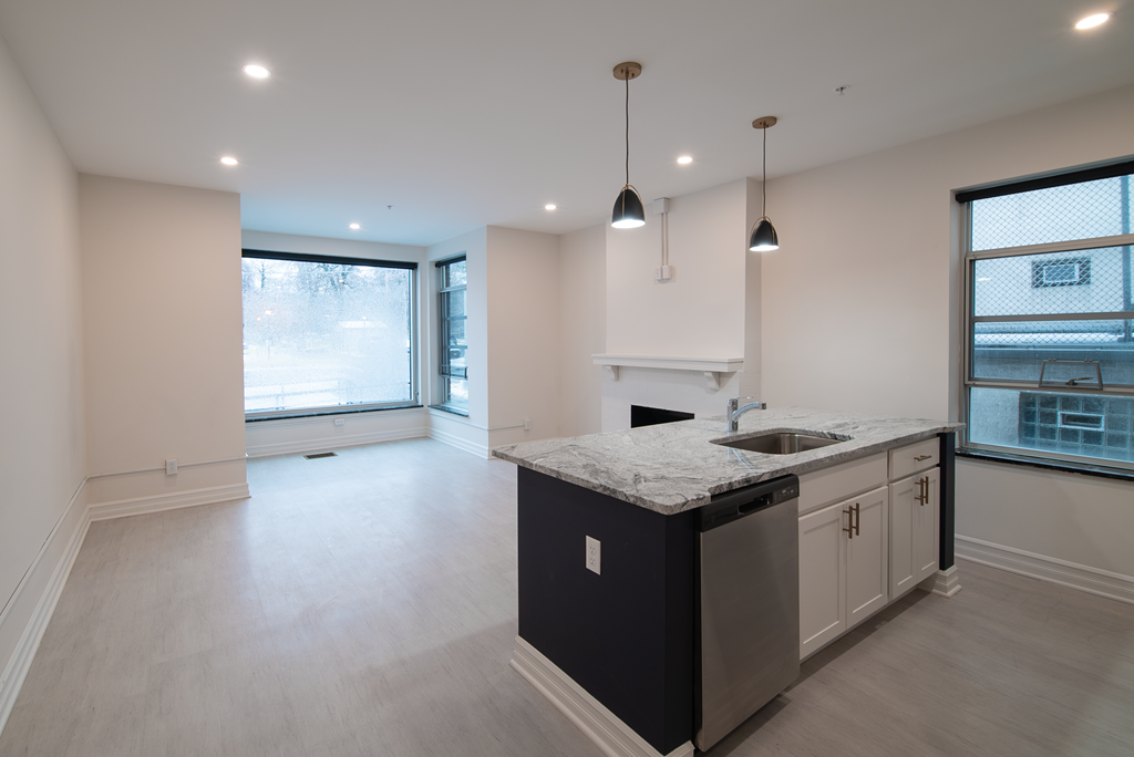 an empty kitchen with an island in the middle