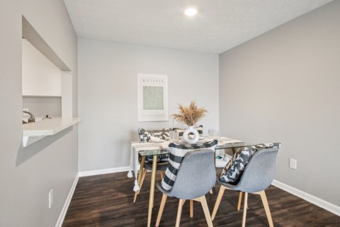 A dining room with a white table and chairs.