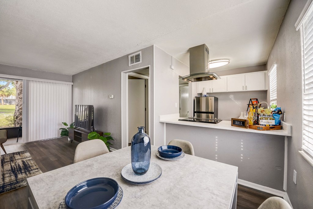a kitchen and dining room with a table and chairs