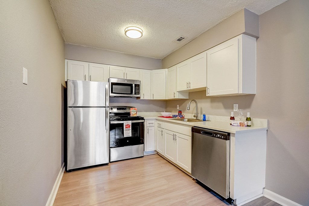 Renovated Apartment Home Kitchen at Fernwood Grove Apartments at 4900 MacDill Ave in Tampa, Florida 33604