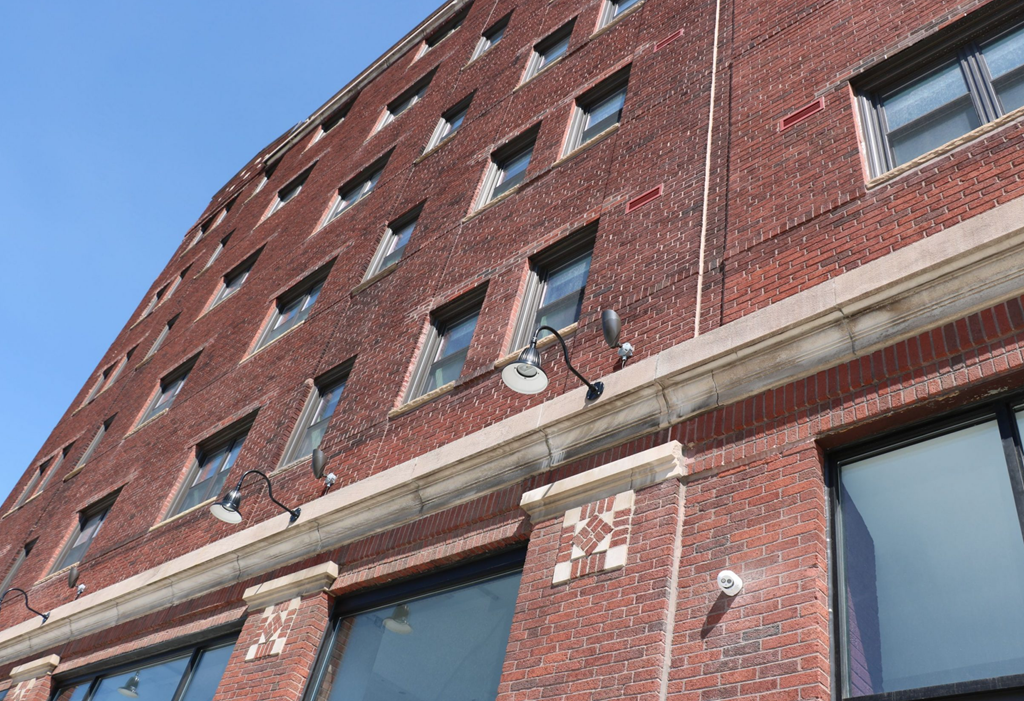 the side of a brick building with a blue sky in the background