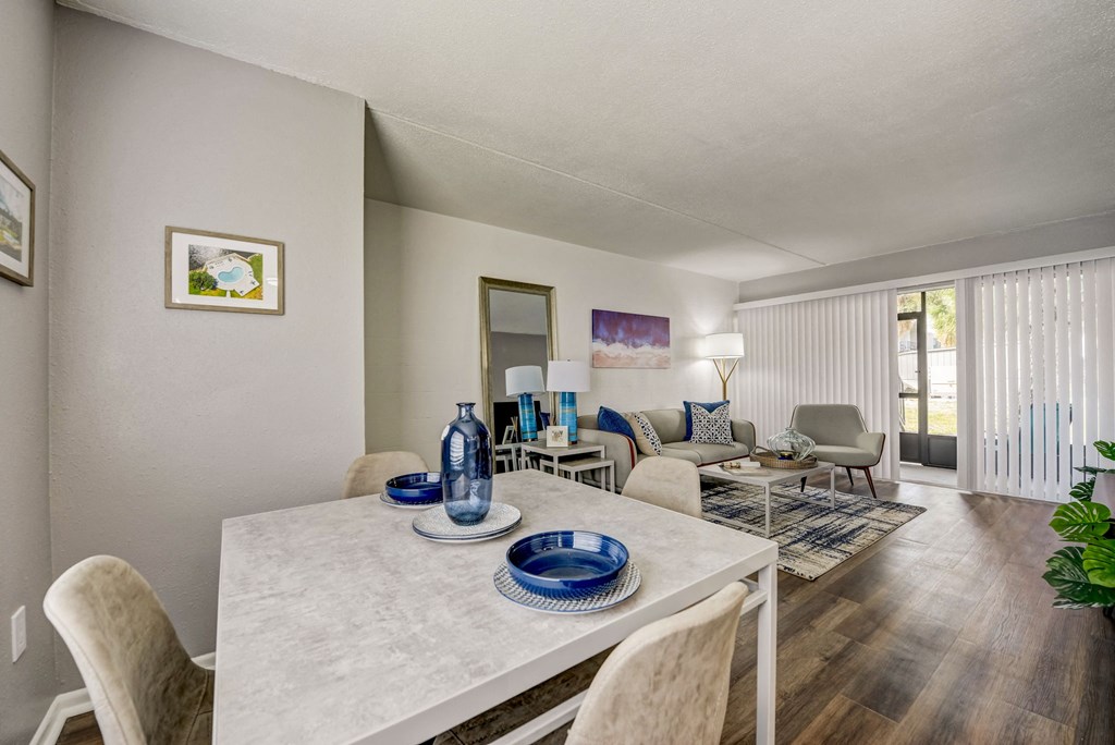 a living room with a dining room table and chairs and a couch
