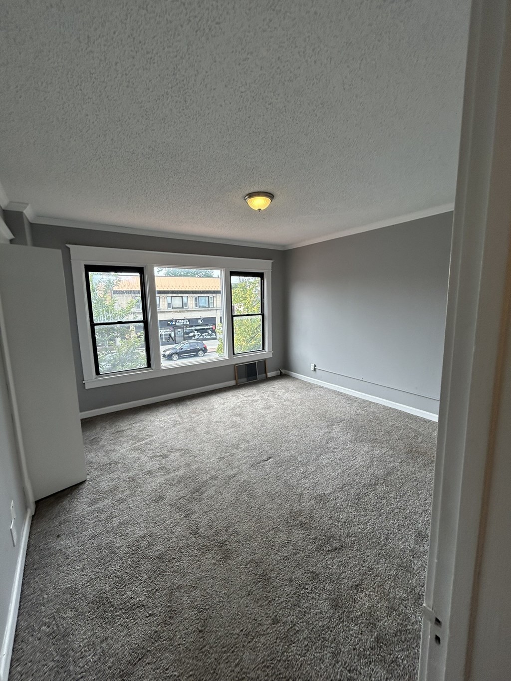 an empty living room with a large window