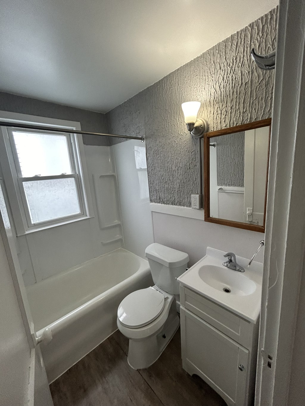 a small bathroom with a sink toilet and bath tub