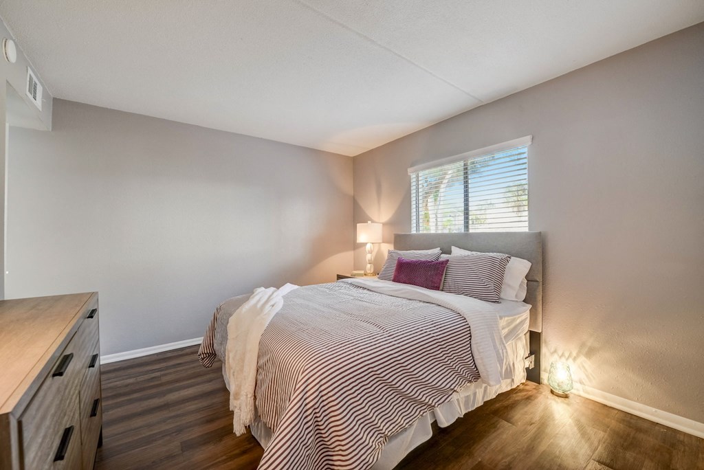 a bedroom with a bed and a window