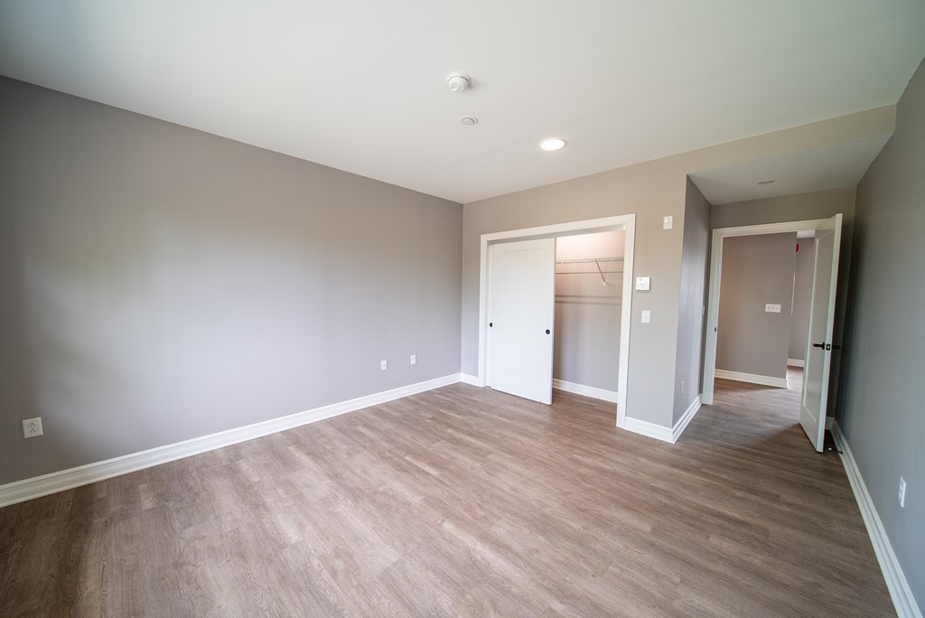 bedroom of apartment 209 showing closet with sliding doors