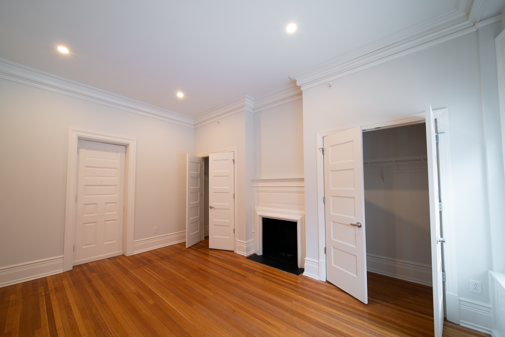 a living room with a fireplace and a closet