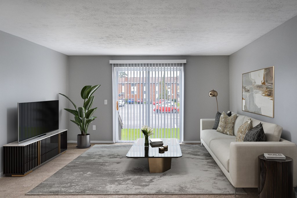 A living room with a white couch, a television, and a coffee table.