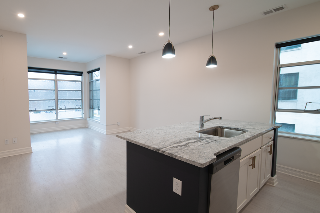 an empty kitchen with a sink and a window