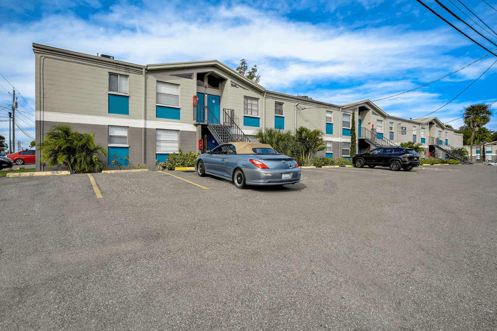 an apartment building with a car parked in front of it