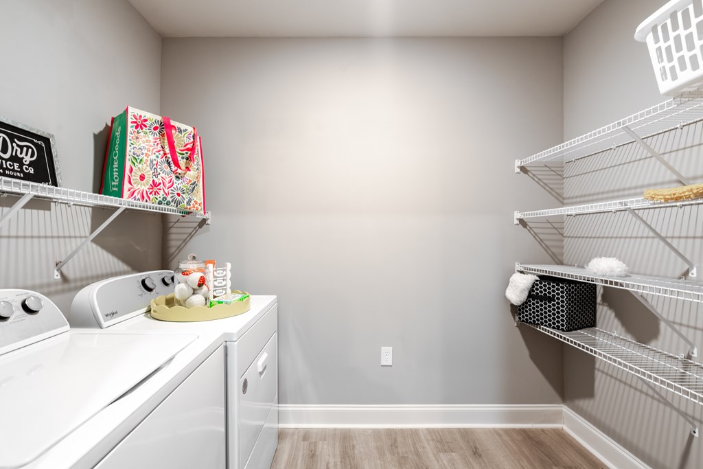 A kitchen pantry with white appliances and shelves.